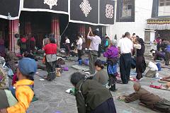 
A prostration is one of the fundamental practices of Tibetan Buddhism to purify our pride, body, speech and mind. You begin with your palms pressed together at the level of your heart, and then touch your hands to your crown point between the eyebrows (mind), the throat (speech), and the heart (body), then stretch your entire body on the ground and stretch both of your hands as far as possible away from your head. Then rise up quickly and repeat at least two more times.
